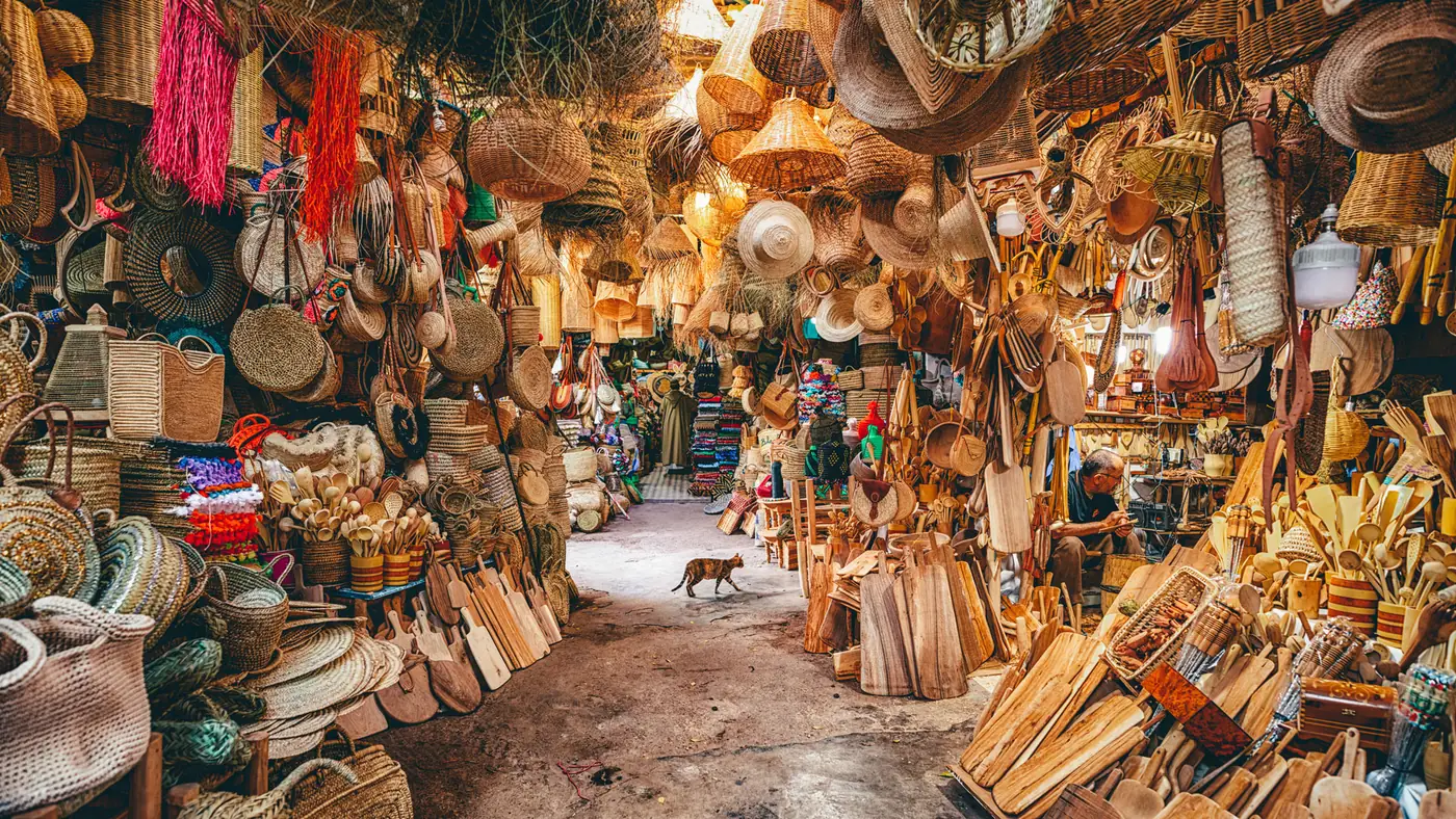 Baskets, hats and woven goods filling an alley in the Marrakech souks